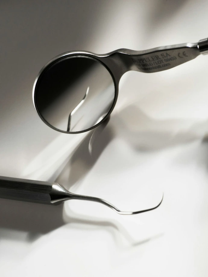 Dental mouth mirror and scaler instrument used by dentists for oral diagnostics, examination, and preventive dental care